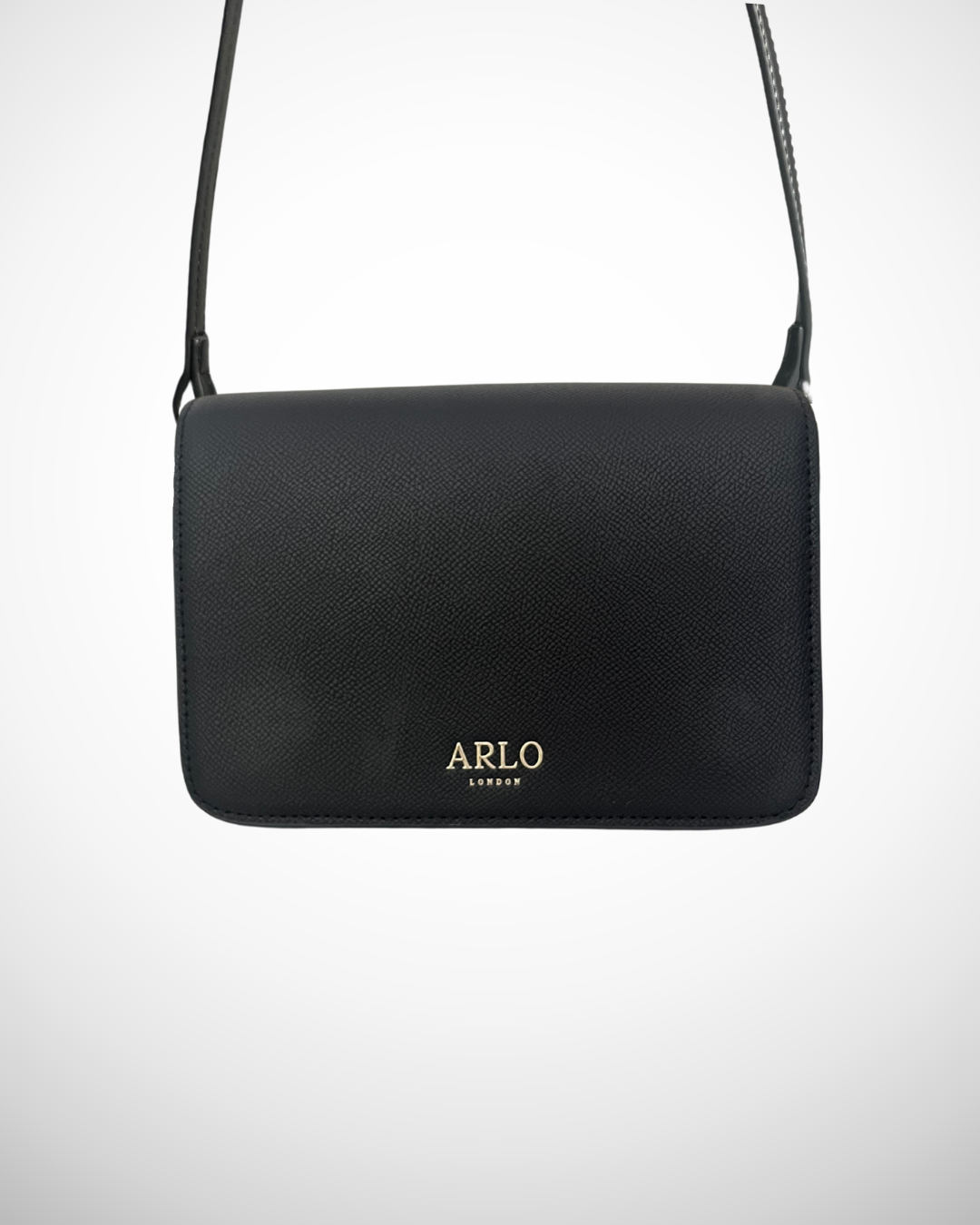 A black and gold vegan textured leather crossbody casual handbag for day use with adjustable strap. Minimal, quiet luxury, sophisticated, understated, simple design by ARLO London. Multiple organisation compartments with magnetic snap button closure