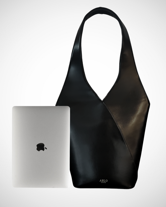 smart sophisticated black structured hobo style large shoulder handbag for work made from smooth patent vegan leather with separate compartments for organisation, long handles, plain, office appropriate, spacious, mid luxury, quiet fashion, matching coffee cup travel flask, laptop carrier