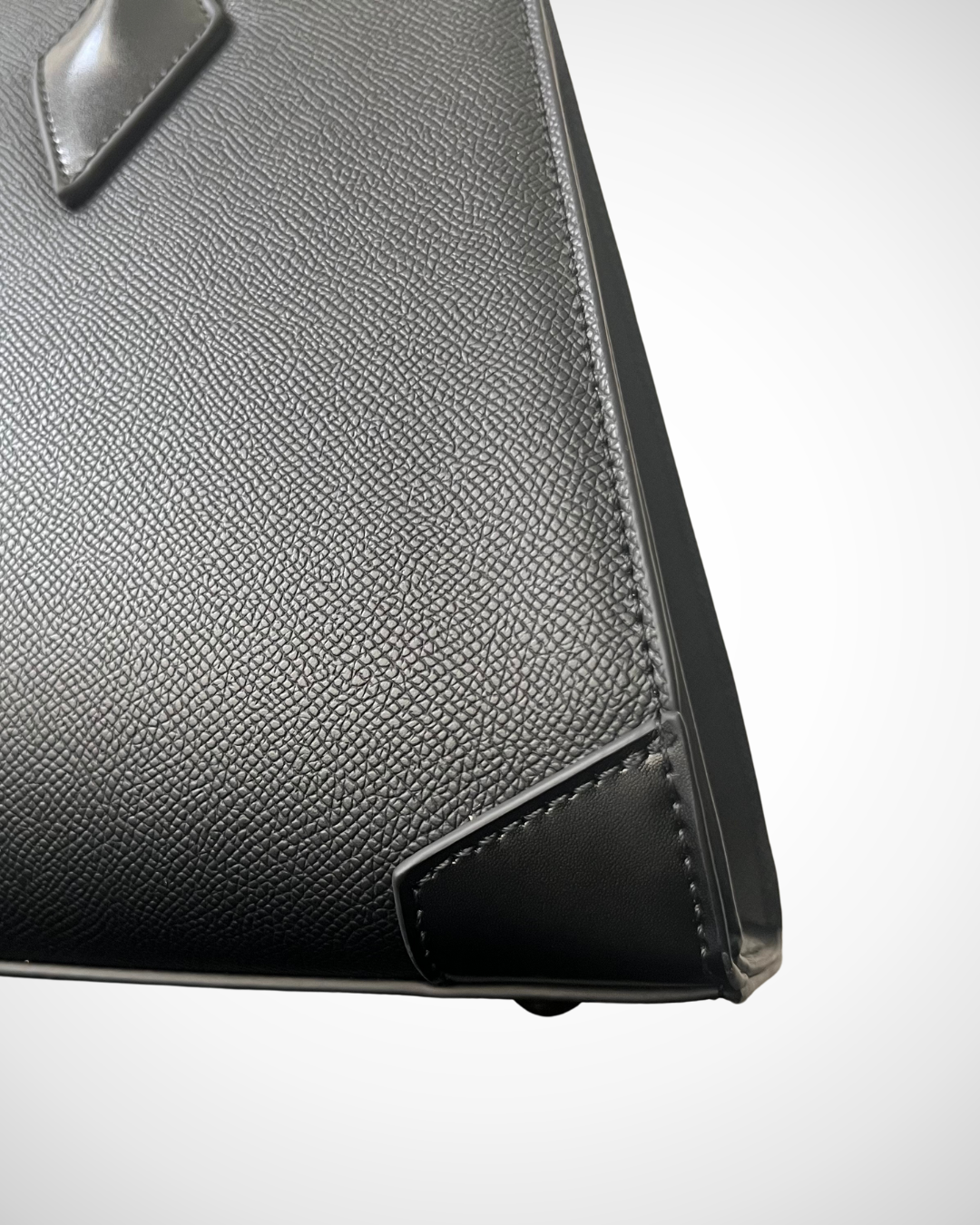 smart sophisticated black structured trapezium tote handbag for work made from vegan leather with separate compartments for organisation, long handles to wear on shoulder or on the arm, plain, office appropriate, spacious, mid luxury, quiet fashion corner reinforcements