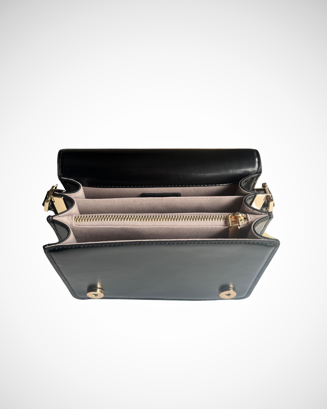 A black and gold vegan textured leather crossbody casual handbag for day use with adjustable strap. Minimal, quiet luxury, sophisticated, understated, simple design by ARLO London. Multiple organisation compartments with magnetic snap button closure