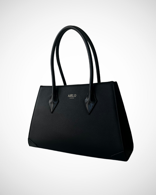 smart sophisticated black structured trapezium tote handbag for work made from vegan leather with separate compartments for organisation, long handles to wear on shoulder or on the arm, plain, office appropriate, spacious, mid luxury, quiet fashion