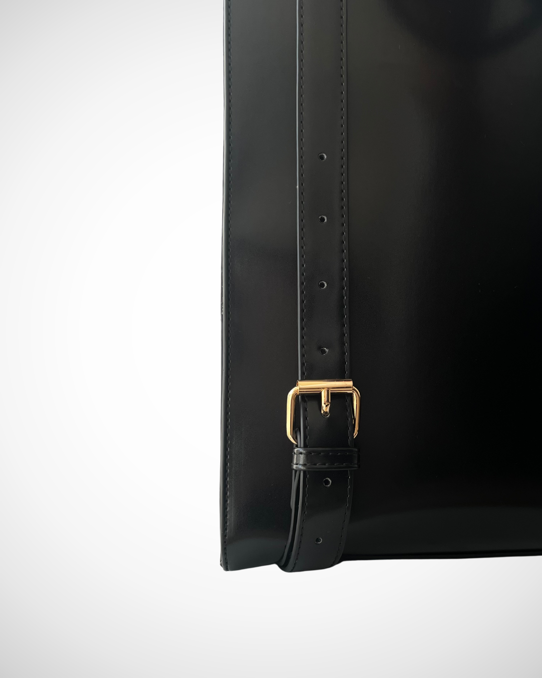 Smart and sophisticated black structured vegan leather backpack / rucksack for laptop with separate compartments including pen loops, zipped inner pocket, smooth patent cruelty-free material for work / office use. Quiet luxury, minimal, mid luxury affordable simple design. Adjustable straps for comfortable wear.